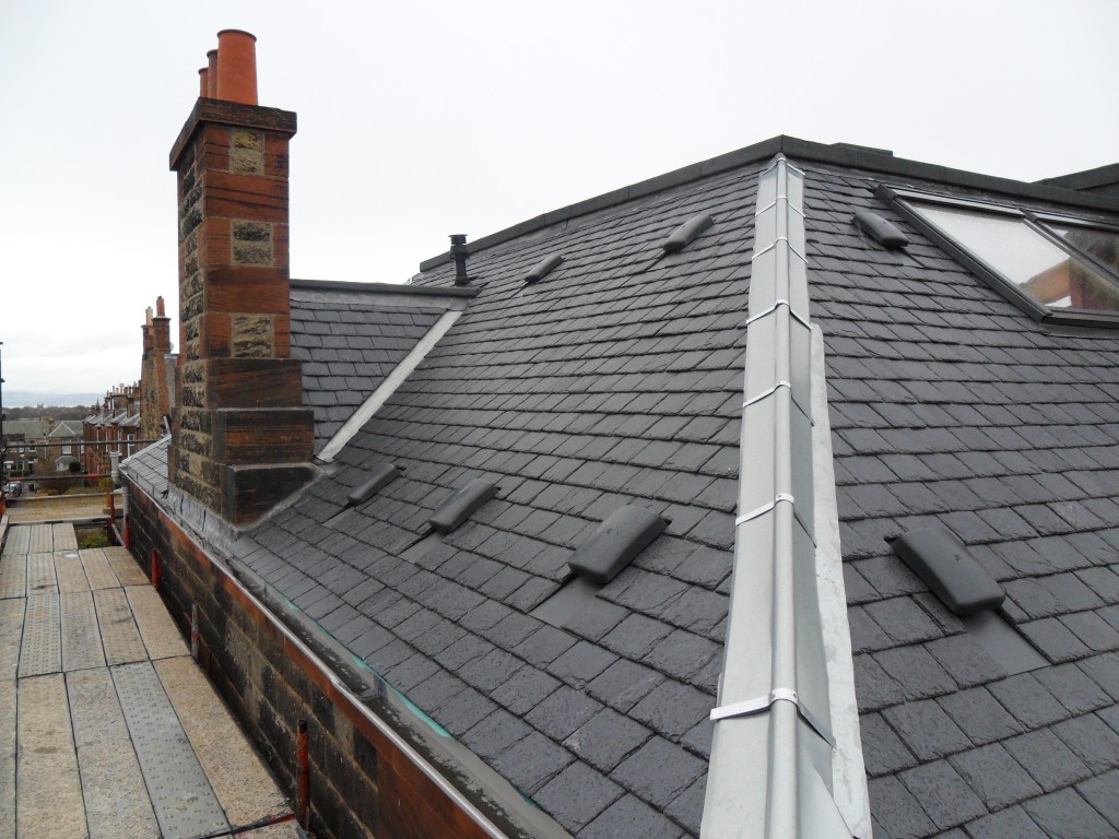 Roofer working on a pitched UK slate roof in Hereford
